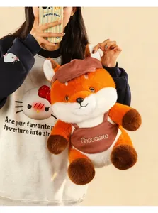 Detailed close-up of a cute orange cartoon fox plush toy being held by a person in a warm setting
