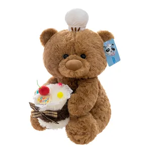Simpatico orsetto di peluche marrone con cupcake e ciliegina per regalo di compleanno