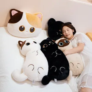 Soft long cat plush body pillow and round cushion with cute cat faces on white bed