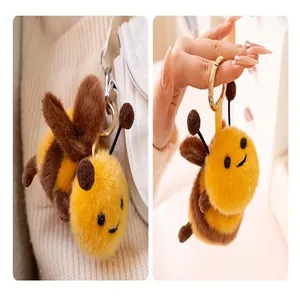Close-up shot of a cute plush bee keychain featuring soft yellow and brown faux fur