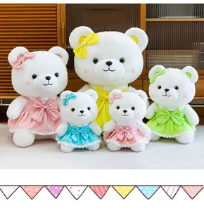 Collection of white teddy bear plush toys wearing colorful princess dresses with bows