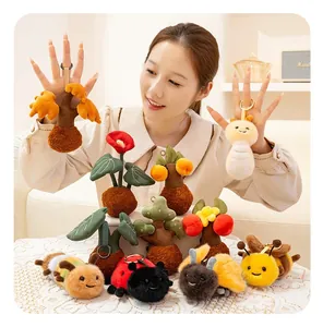Detailed group photo of cute plush insect and plant keychains held by an Asian model