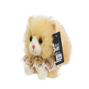 Detailed view of cream plush cat toy wearing a decorative lace scarf and tag