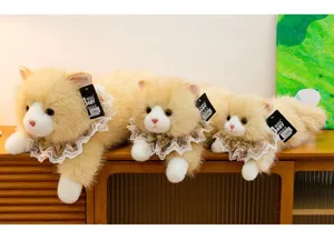 Detailed view of three sizes of fluffy beige ragdoll cat plush toys on a wooden cabinet.