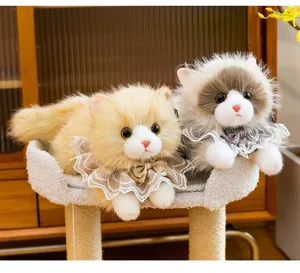 Detailed view of two cute ragdoll cat plush toys with lace collars and bows.