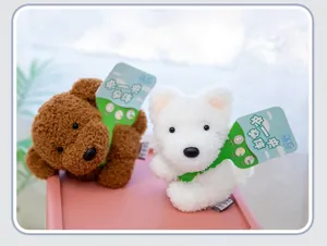 Pair of cute fluffy plush dog keychains in brown and white with decorative green tags