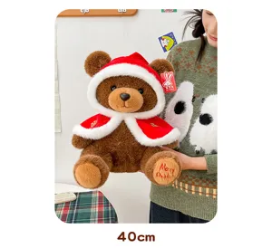 Detail view of 40cm Christmas teddy bear plush with red hooded cape and white trim