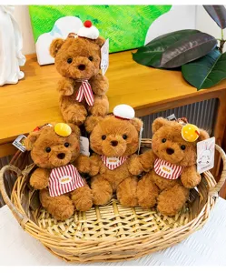 Set of cute brown teddy bear plush keychain charms with striped scarves in a basket.