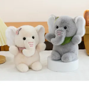 Set of two cute plush elephant dolls with colorful scarves in a cozy room setting