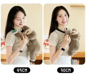 Comparaison de tailles de peluches paresseux marron de 45 cm et 30 cm par un modèle.
