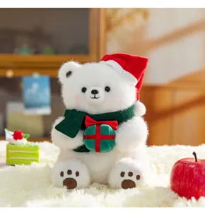 Orsetto di peluche natalizio bianco con cappello rosso e sciarpa verde