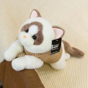 Vista detallada de un suave peluche de gato con un suéter de punto marrón para niños