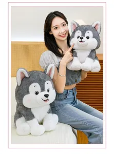 Detailed view of adorable grey and white husky plush toys held by a smiling model