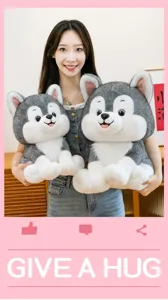 Detailed view of two cute soft plush husky dog toys being held by a smiling girl