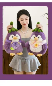 Detailed view of two cute purple penguin plush toys with eggplant themed outfits.