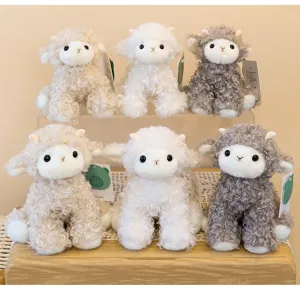 Group of soft curly lamb plush toys in white, beige, and grey colors