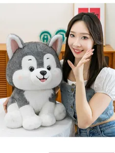 Large plush Husky dog toy held by a woman, showing its soft texture and large size