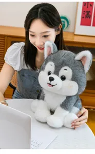 Detailed view of a realistic Husky dog plush toy held by a model in a cozy home setting