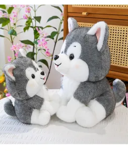 Close-up detail of two cute grey and white husky dog plush toys in a cozy home environment