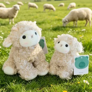Cute curly sheep plush toy set with soft white fur, presented in a green field