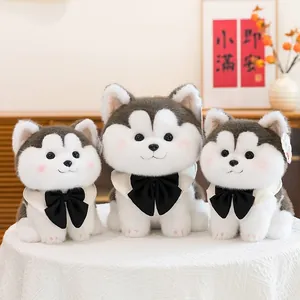 Set of three cute husky plush toy dogs with black bowties and cream scarves on lace
