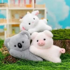 Adorable cartoon plush animal toys including a koala pig and goat in a cozy outdoor setup