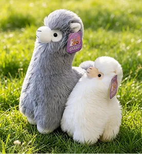 Detail showing the soft and fluffy texture of grey and white alpaca plush toys.