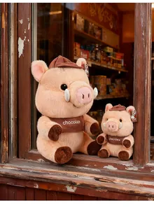 Maillard style pig plush toys in two sizes sitting on a vintage window sill