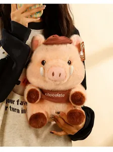 Close-up of a cute Meillard plush pig wearing a brown hat and bib labeled chocolate.