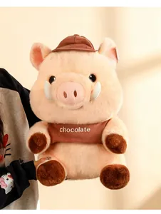 Detail shot of a cute Maillard pig plush toy with brown cap and chocolate vest
