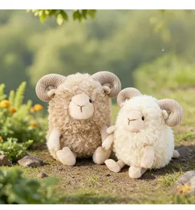 Detailed view of two cute curly plush sheep dolls sitting on green grass outdoors