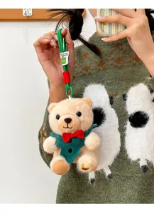 Detailopname van een kerst teddybeer knuffel met een groen vest en een rode strik