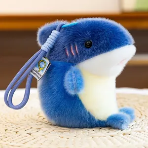 Cute blue and white plush shark keychain charm with soft fur texture and purple rope