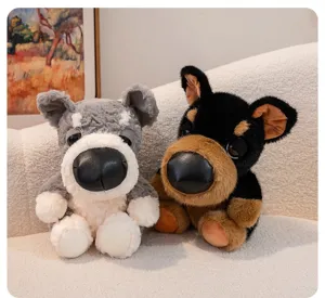 Two adorable big-nose dog plush toys in grey and black sitting on a cozy textured sofa