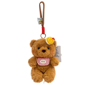 Cute brown plush bear keychain pendant with striped bib and lanyard.