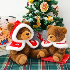 Two adorable Christmas teddy bear plush toys wearing red festive capes for holiday decor