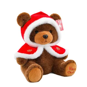 Adorable brown Christmas teddy bear plush toy wearing red hooded cape with snowflakes