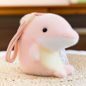 Cute pink and yellow orca plush keychain charm with soft fur and woven rope strap