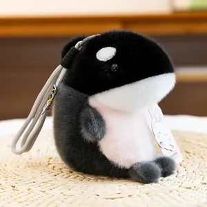 Cute fluffy orca plush keychain with gray strap and soft black white fur for bags