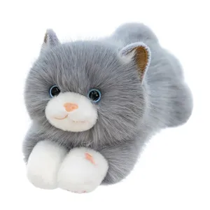 Realistic plush ragdoll cat toy in soft grey and white prone position