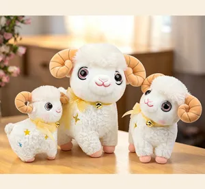 Cute plush sheep toys set with bells and star embroidery on wooden table background.