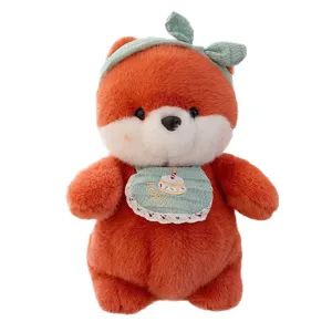 Adorable orange fox plush toy featuring a green bib and headband on white background