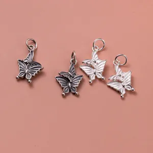 Exquisite detail of 925 silver double butterfly pendants in vintage and polished finishes.
