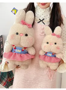 Detailed view of two cute bunny plush toys wearing stylish red checkered dresses