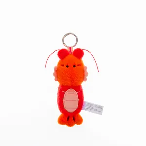 Close-up of a cute orange plush lobster keychain with soft fur texture and metal ring