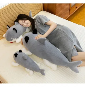 Detailed view of creative shark dog plush pillows in three sizes on a cozy bed