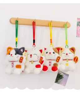 Details of plush lucky cat hanging pendants with lucky embroidery, cute and festive decor.