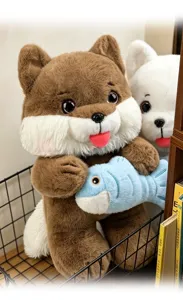 Macro detail of a cute brown cat plush toy holding a blue fish accessory in a cozy setting