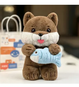 Detailed close-up showing a cute brown plush kitten holding a soft blue fish toy