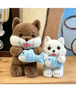 Detailed view of two cute plush cat toys in brown and white holding blue fish dolls